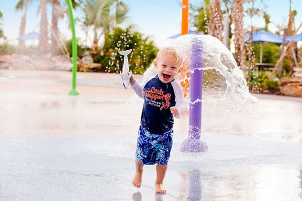 Kid enjoying splash area at Lakeside park in Waterset