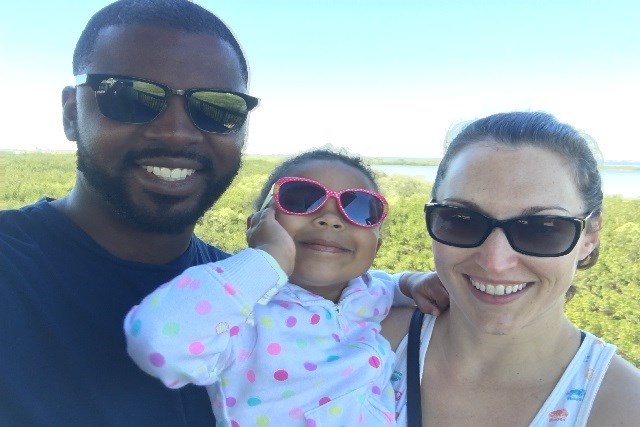 Family with toddler smiling