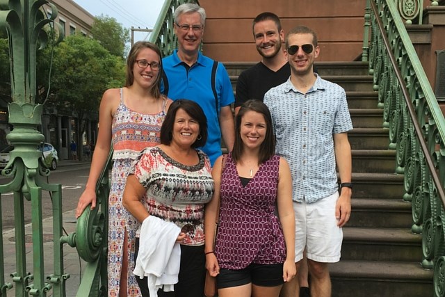 Multi generational family outdoors standing on stairs