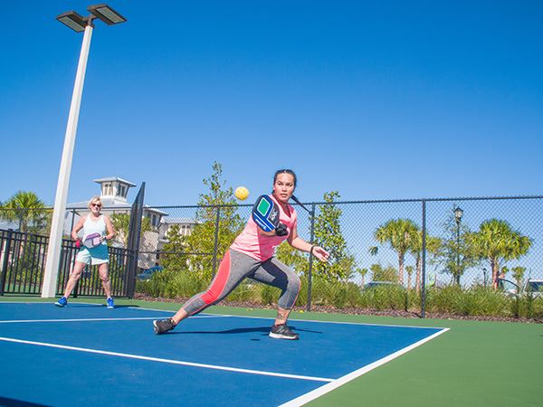 Woman playing pickleball on court in Waterset.