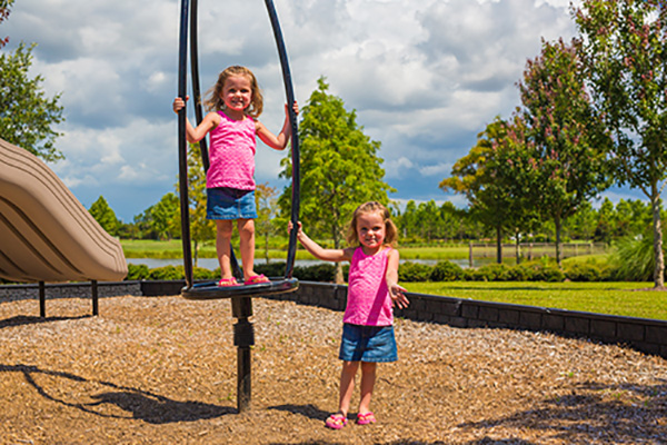 Kids enjoying the Landing Club playground in Waterset.
