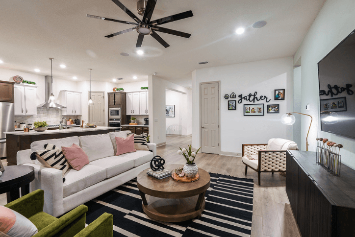 Neutral living room with pops of pink and green in a David Weekley model home in Apollo Beach