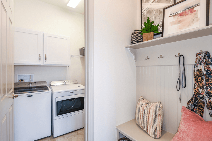 Laundry area with bench, hooks and shelving.