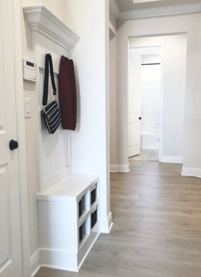 Shelving and hooks in foyer area.