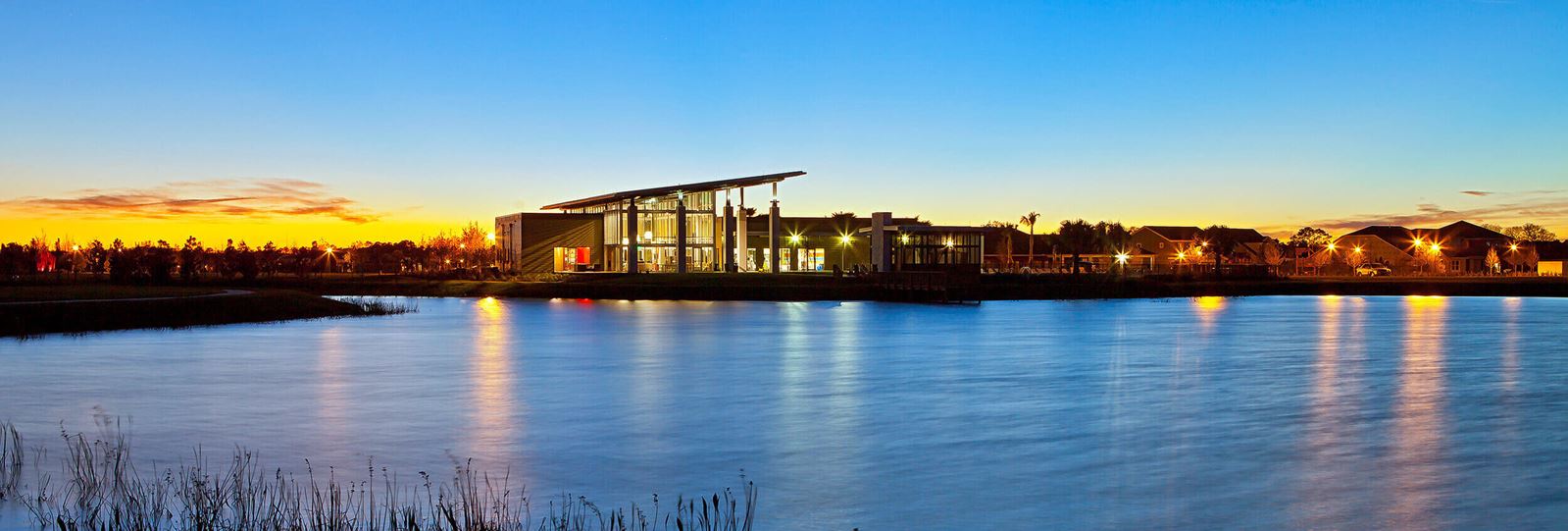 View across the pond of The Landing, New Home Information in Waterset.