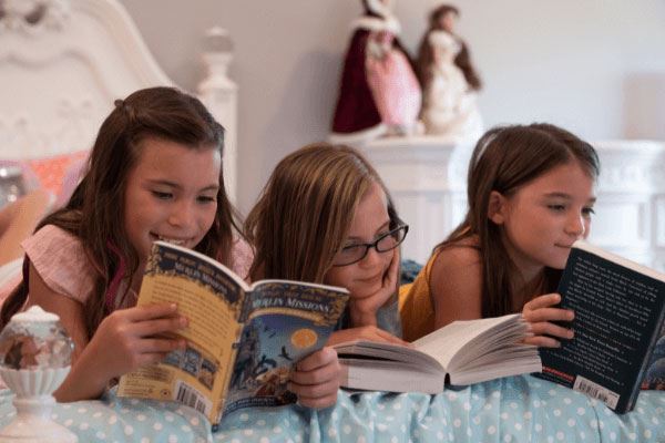 girls reading a book together
