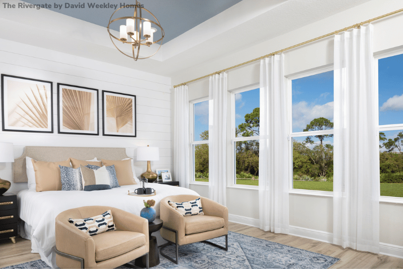 Blue and white bedroom with large open windows